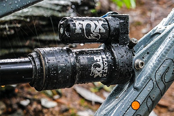 A close up view of a wet Rear Fox Shox on the Alpine 6